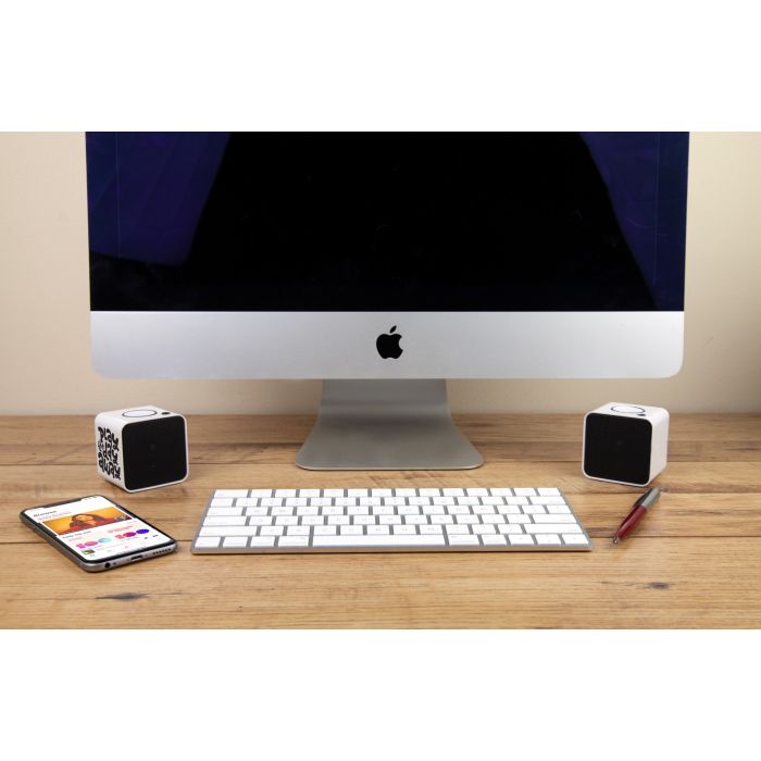 2 branded cube speakers on desk
