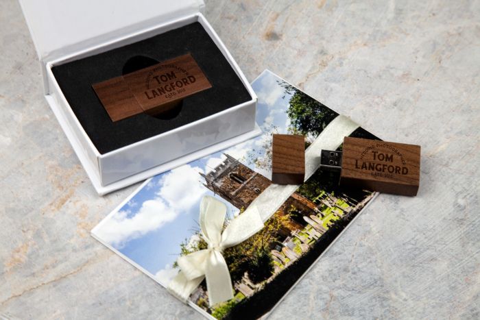 dark wooden usb with a white gift box with wedding photo prints