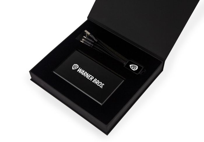power bank and cable with warner bros logo in black branded box