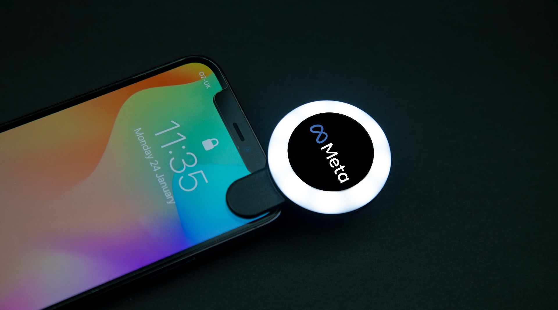 selfie ring light clipped onto iphone printed with meta logo