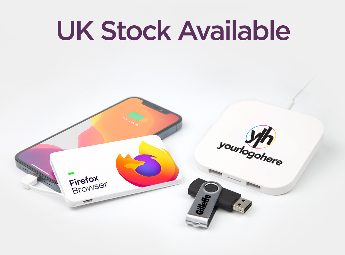 Credit card power bank plugged into an iphone with a wireless charger and twister USB stick all branded with a company logo. Caption 'UK Stock Available'