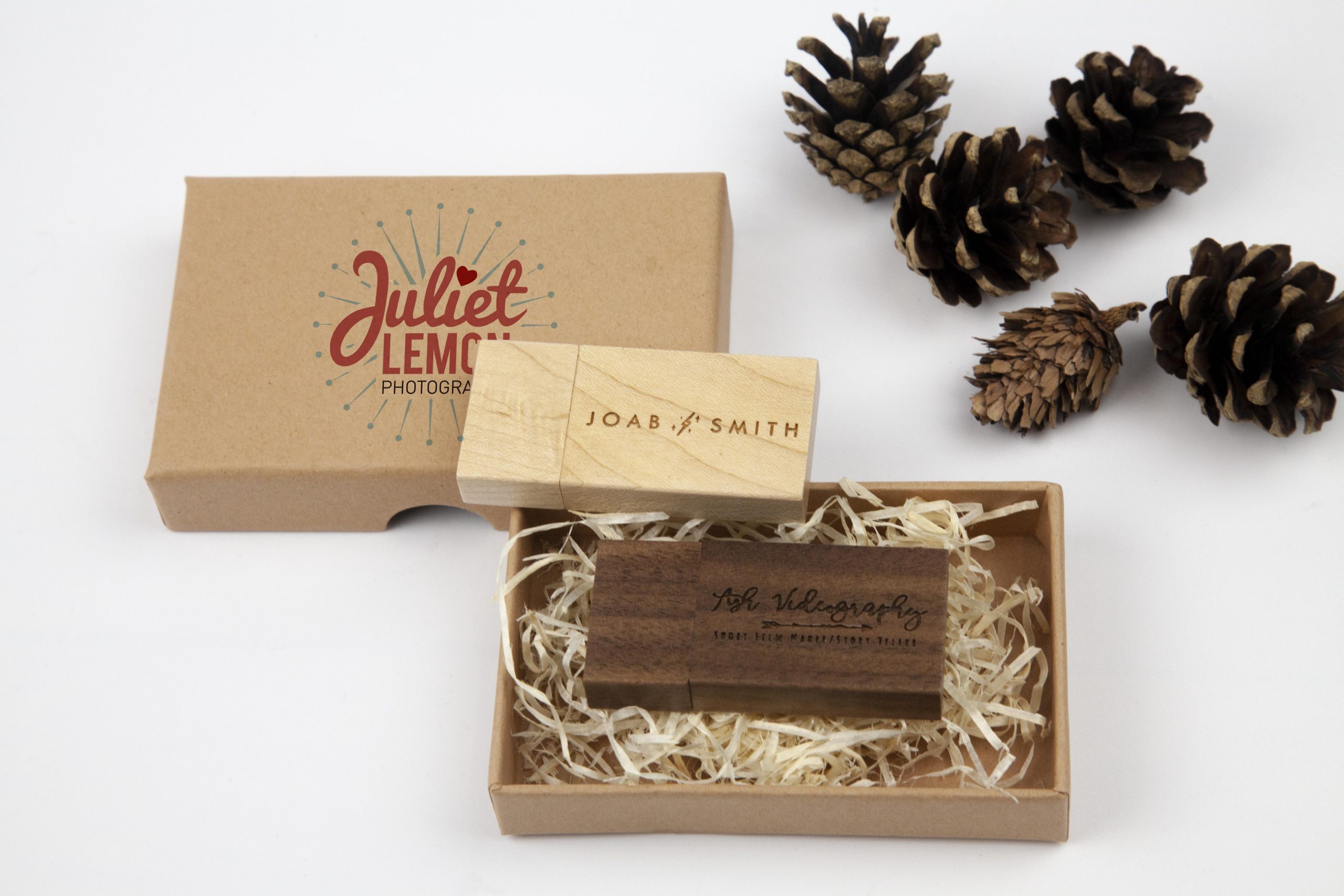 Eco Kraft Box printed with photography logo with wooden USB stick and wood wool. pine cones on the side for decorative effect