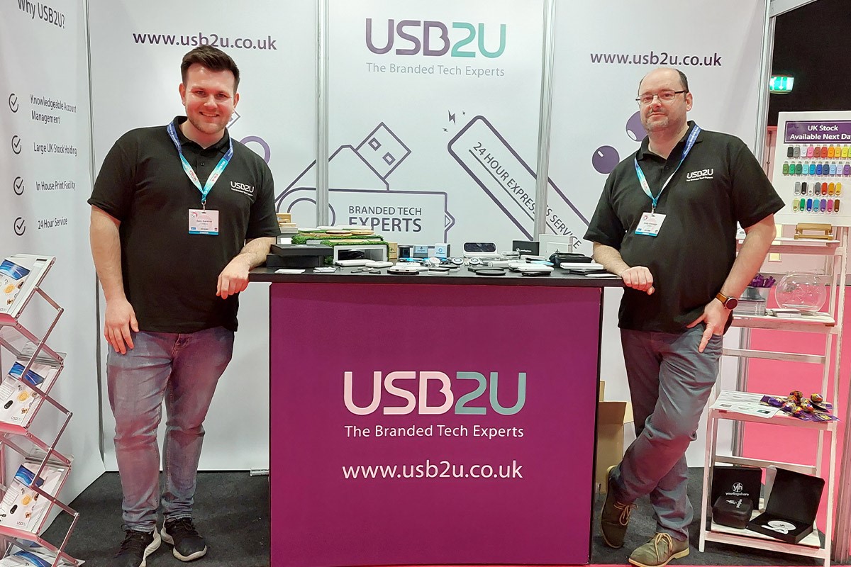 Andy and Sam from USB2U's trade team standing on their stand at Merchandise World exhibiting